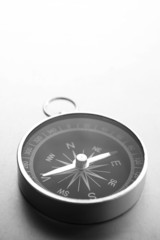 Compass on a gray gradient background, place for text