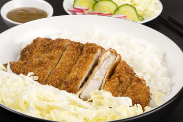 Tonkatsu served with shredded cabbage and steamed rice.