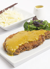 Tonkatsu served with shredded cabbage and curry sauce