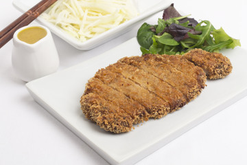 Tonkatsu served with shredded cabbage and curry sauce