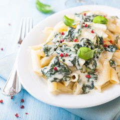 Penne pasta with blue cheese sauce and spinach