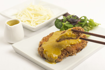 Tonkatsu served with shredded cabbage and curry sauce