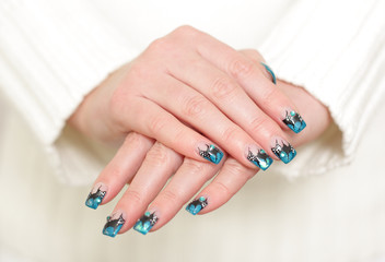 Obraz na płótnie Canvas Female hands with blue manicure