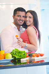 Happy young couple having fun in the modern kitchen
