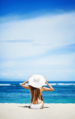 young woman in white swimsuit on the beach, bali - obrazy, fototapety, plakaty