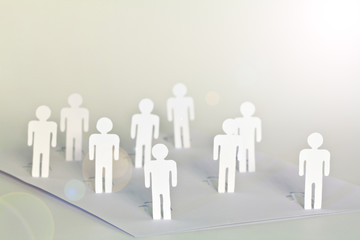 close up of people cut out of paper on table