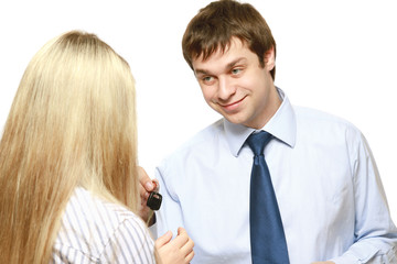 A male realtor giving keys to a woman