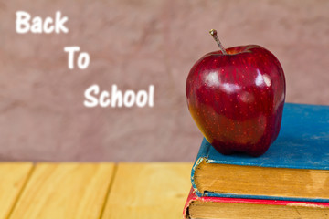 Stack of books with a red apple