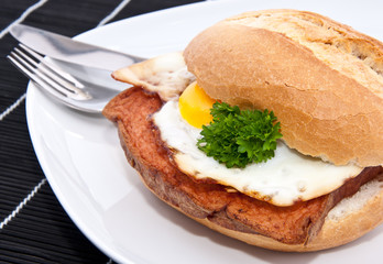 Roll with meat loaf on a plate