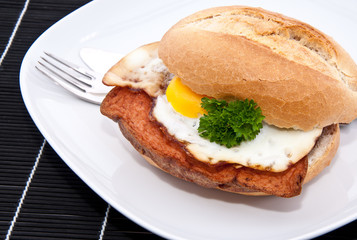 Roll with meat loaf on a plate