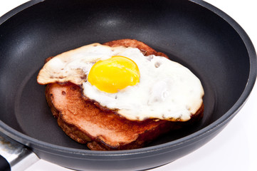 Meat loaf and fried egg in a skillet