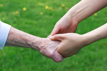 Senior and Young Women Holding Hands