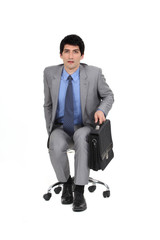 Businessman sat with briefcase