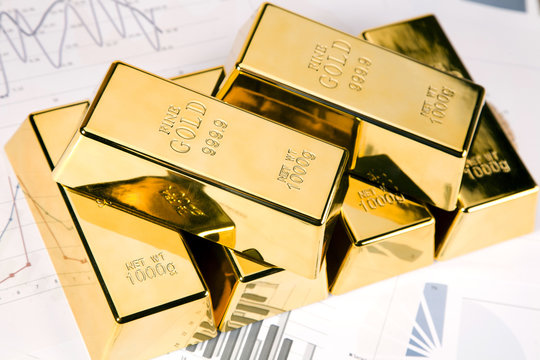 Gold bars on graphs and statistics, studio shots, closeup