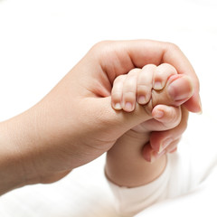 baby holding mother hand