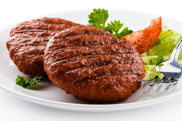 Grilled beefsteaks and vegetables