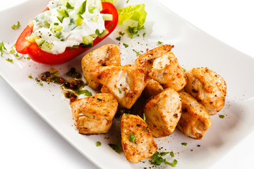 Grilled meat and vegetables on white background