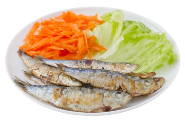 fried sardines with lettuce and carrot on the plate