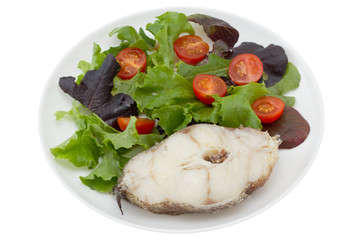 boiled fish with salad in white plate