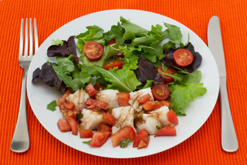 boiled fish with sauce and vegetable salad