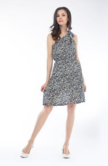 Young fashion model in grey cocktail dress isolated on white