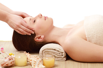 Fototapeta na wymiar A beautiful woman getting massage in a spa center