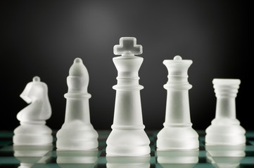 glass chess pieces in dark