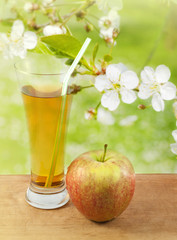 Apple juice in spring garden abstract