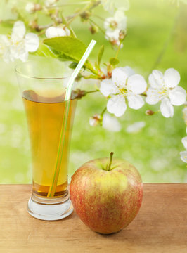 Apple juice in spring garden abstract