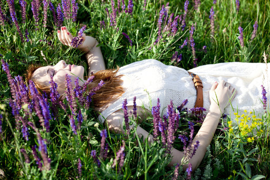 Young fashion girl lying down at green grass.