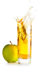 orange juice is spalsing in glass