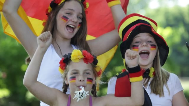 three girls cheering for the german team