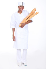Female baker with loaves of bread