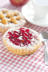 beautiful cake with berries and tea on plaid fabric