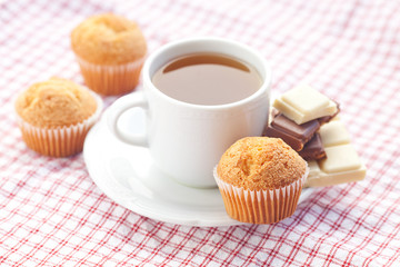 bar of chocolate,tea and muffin on plaid fabric