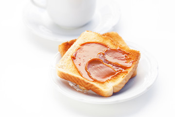 tea and toast with caramel isolated on white