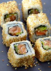 sushi with salmon and cucumber with sesame seeds