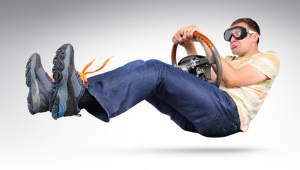 Funny driver in goggles with a wheel, auto concept