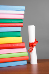 Diploma and stack of books