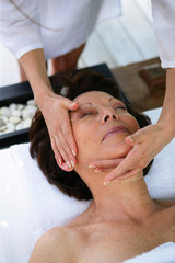 Fototapeta na wymiar Woman having her face massaged