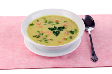 Tasty soup on pink tablecloth isolated on white