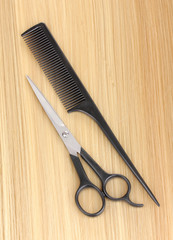 Shiny blond hair with hair cutting shears and comb close-up