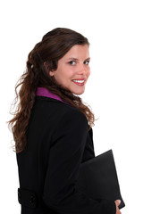 Brunette woman holding folder under arm