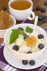 A healthy breakfast of cheese, berries and honey