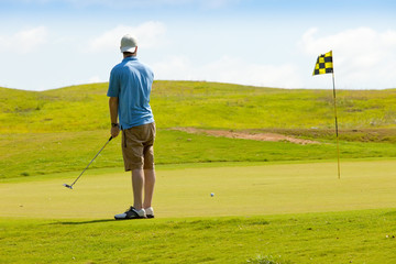 Young golfer on putting green