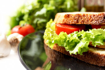 salad, bacon  and tomato sandwich
