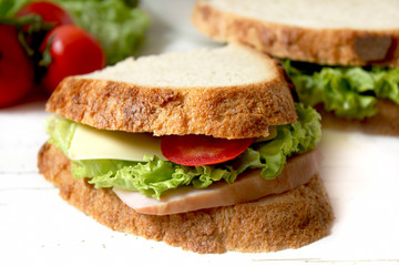sandwich with tomato, cheese, bacon and salad