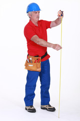 Builder with a tape measure