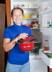 woman  with pan the fridge
