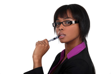 Businesswoman chewing on her pen - Powered by Adobe